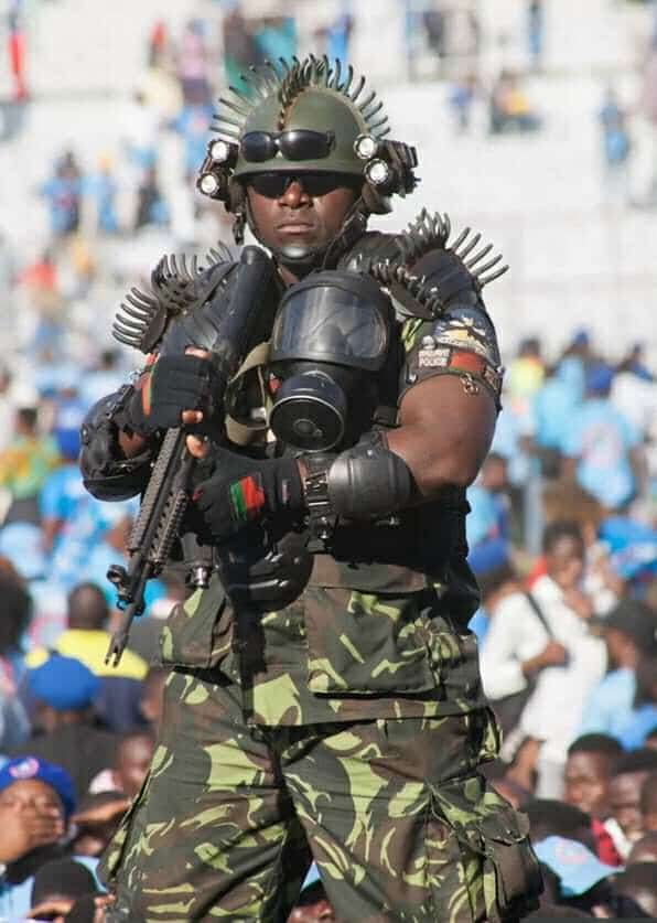 World’s scariest bodyguard kitted out with bizarre spiked jacket, gas mask, assault rifle and two pairs of sunglasses at Malawi President Mutharika’s swearing in ceremony