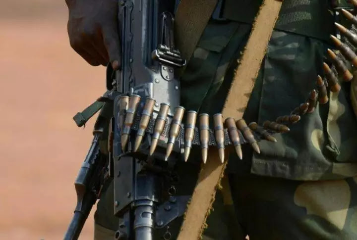 African soldier fires gun into mouth to test bullet charm