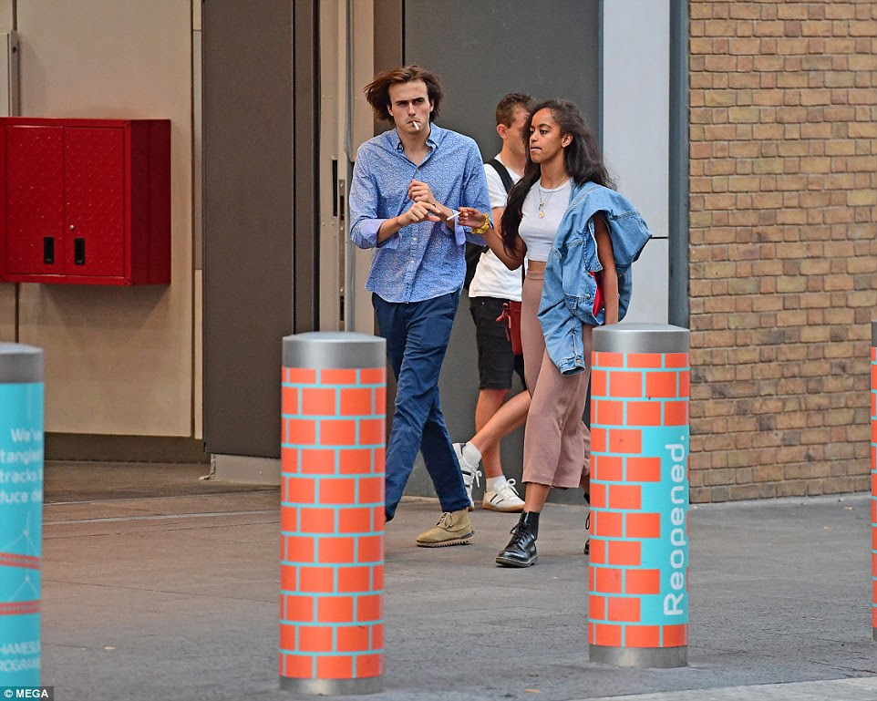 Malia Obama pictured snuggling up to her British boyfriend in a London underground station before the couple lit matching cigarettes during her trip to Europe