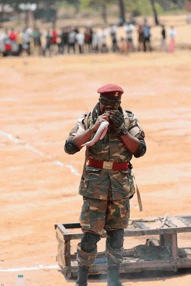 President Lungu tasting snake roasted by Zambia Army Commandos