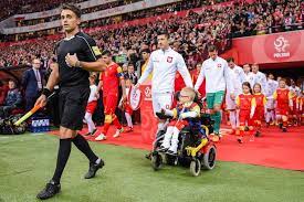 Why footballers walk out with children to the playing field